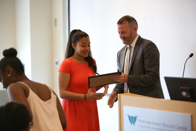 EPIC program participant, Aaliyah Colon, receives a diploma for completing the year-long program.