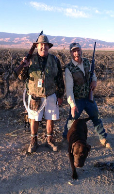 Bob Coyle, left, without a human heart goes hunting with his friend since age ten, Jeff Galieti. Bob's dog Diesel joins in the hunt. Coyle is seen with the air tubes that connect the SynCardia Heart to the Freedom(R) portable driver that he carries in a backpack.