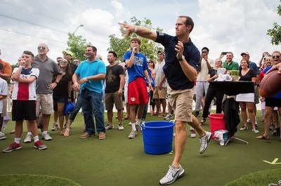 Drew Brees throws a football at the Brees Topgolf Challenge