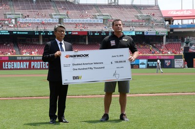 Hankook Tire America Corp. President Hee-Se Ahn presents DAV Executive Director Barry Jesinoski with a $150,000 check during an on-field presentation at the Cincinnati Reds Military Appreciation Day Game at the Great American Ball Park on June 12. Hankook has renewed its partnership with DAV to help provide free services to veterans of all generations where they live.