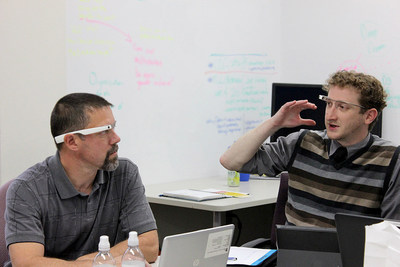 Employees in the Erie Insurance Commercial Risk Control group discuss a new program in which managers employ Google Glass to provide remote underwriting guidance to field consultants(left, Ron Dietrich, senior risk control consultant, Erie Insurance; right, Brett McCorkle, IT analyst, Erie Insurance)