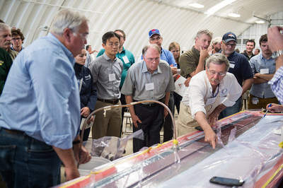 Attendees of Composites in Wind participate in a LRTM demo of a nacelle as Jim Noonan, Technical Support Manager, Composites One and Rick Pauer, Applications Manager, Polynt Composites, discuss the advantages that LRTM has to offer those considering converting to closed molding.