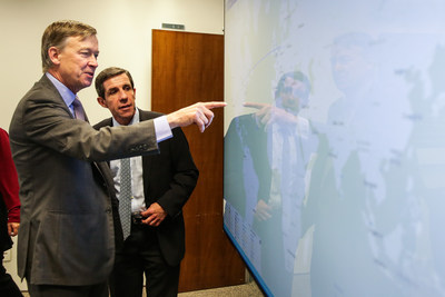 Colorado Governor Hickenlooper and Gabriel del Campo, Level 3, take in a real-time threat map in Level 3's São Paulo Security Operations Center.