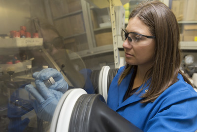 IBM scientist, Jeannette Garcia, Ph.D., examines purified, non-toxic plastic created from recycled smartphones and CDs.