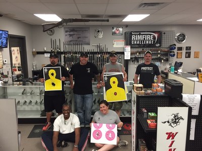 Warriors show off their targets after a day at the firing range in Ottawa, Kansas.