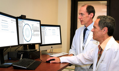 VA oncologists Michael Kelley (left) and Neil Spector review a Watson for Genomics DNA analysis report. On Wednesday at VP Biden's National Cancer Moonshot Summit, VA and IBM launched a public-private partnership to help doctors expand and scale access to precision medicine over the next two years for 10,000 American veterans with cancer. (Photo Credit: Martha Hoelzer)