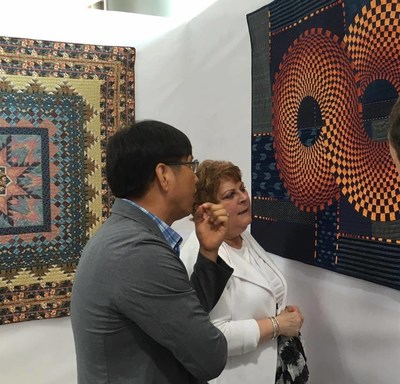 Two quilts from The Collection of The National Quilt Museum at The Woljean Museum, Incheon Korea. In front: "Infinity" by Nancy Ota. In back, "Tulips Aglow" by Mary Kay Hitchner.
