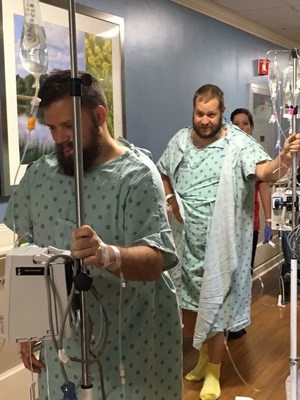Andrew Coughlan and Russell Broughton go for a walk at IU Health University Hospital in Indianapolis just days after Andrew donated his kidney to Russell.
