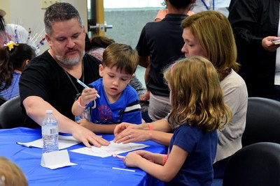 A veteran family designs their family crest during a Wounded Warrior Project event.