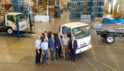 First Chevrolet Medium Duty Truck Rolls Off the Line at Spartan Motors. People- Left from right: Thomas A. Meisel, Isuzu North America Corporation, Takusei Nakagawa, VP CV Product Planning, Isuzu North America Corporation, Kevin Brewer, Medium Duty Marketing and Sales Manager, General Motors Fleet, Daryl Adams: President and CEO, Spartan Motors, John Schwegman, U.S. Director of Commercial Product, General Motors Fleet, Steve Guillaume, President, Spartan Specialty Vehicles, Paul Loewer, Medium Duty Product Manager, General Motors Fleet