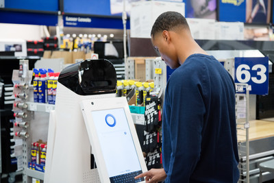 LoweBot helps a customer pull up product information.
