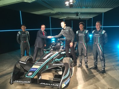 Lear vice president, E-Systems Europe & Africa, Mariano de Torres at center left shaking hands with Panasonic Jaguar racing team director James Barclay with drivers Ho-Pin Tung, Mitch Evans, and Adam Carroll.