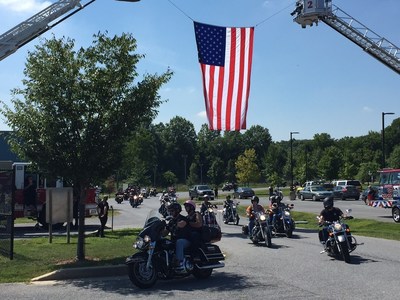 Motorcycle riders cruise around a corner during the Second Annual Ride with the Heroes. A group of injured veterans with Wounded Warrior Project escorted hundreds of motorcycle riders across Maryland on a 65-mile rural tour. The ride is an annual community event that recognizes service members including military, firefighters, and police.