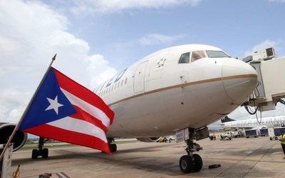 Puerto Rico flag in front of United airplane