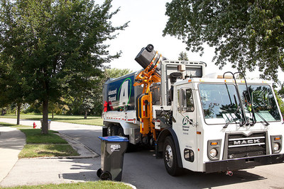 Advanced Disposal automated side-loading truck collecting 96-gallon cart in residential neighborhood.