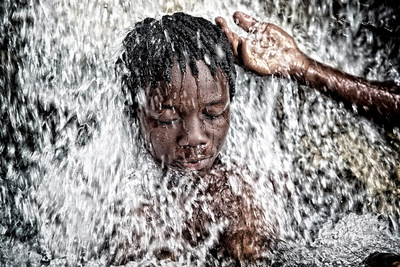 Vodouisant getting cleansed by the sacred waters of Saut-D'Eau in Haiti.