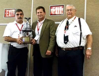 Jimmy Faulkner of Dallas Fire Rescue receives Spartan Motors' William Foster award. Pictured left to right: Jimmy Faulkner, John Slawson, and Bill Foster.