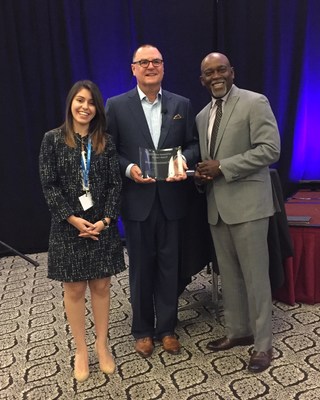 American Association of Airport Executives President and CEO Todd Hauptli (center) presents Miami-Dade Aviation Department (MDAD) Senior Public Relations and Digital Marketing Specialist Jessica Marin (left) and MDAD Division Director for Information Systems Maurice Jenkins, C.M. (right) with the inaugural Airport Innovation Award.