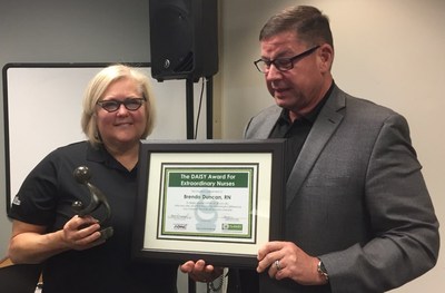 Cross Country Healthcare Chief Clinical Officer Hank Drummond, PhD, MDiv, BA, RN, presents Cross Country Healthcare travel nurse Brenda Zito with the Daisy Award for her work during the 2016 Project Perfect World medical mission trip to Guayaquil, Ecuador.