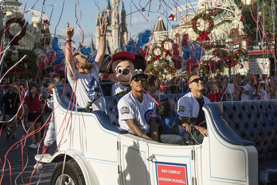 World champions (L-R, top to bottom) MVP Ben Zobrist, Addison Russell and Javier Baez, of the Chicago Cubs are joined by Mickey Mouse and Goofy in a magical moment as streamers fall from the sky Saturday, Nov. 5, 2016, at Magic Kingdom Park in Lake Buena Vista, Fla. The players were honored among thousands of fans at Walt Disney World in a parade celebrating the team's historic victory. (David Roark, photographer)