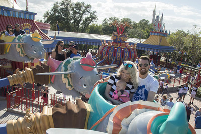 World champions (front to back) MVP Ben Zobrist, Javier Baez and Addison Russell, of the Chicago Cubs, take flight with their families aboard Dumbo the Flying Elephant, Saturday, Nov. 5, 2016, at Magic Kingdom Park in Lake Buena Vista, Fla. The players were later honored among thousands of fans in a parade at Walt Disney World celebrating the team's historic victory. (Preston Mack, photographer)