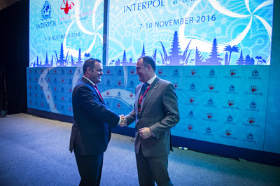 Chris Malo (left), head of global maritime security for Carnival Corporation, and Mick O'Connell (right), director of operational support and analysis for INTERPOL, shake hands following a vote at INTERPOL's General Assembly where Carnival Corporation was announced as the first maritime company to partner with the organization for advanced security screening across its global operations. Carnival Corporation received approval at the Assembly to integrate its global passenger check-in process with...