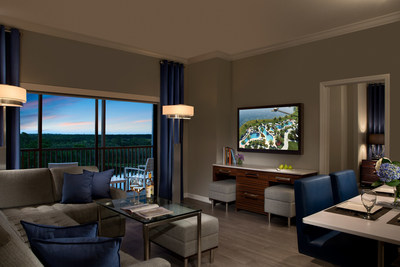 A guest suite living room at The Grove Resort & Spa, a new, all-suite hotel destination opening February 2017 in Orlando, just five minutes west of Walt Disney World. This 106-acre resort sits lakefront on a portion of Central Florida's conservation grounds. The Grove will feature all-suite accommodations with one, two and three bedroom layouts, as well as four swimming pools, multiple dining and drink venues, water sports, a spa, game room, event facilities, and an on-site water park.