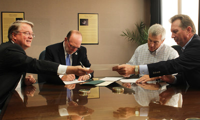 From left: Mark Grambergs, EdR Vice President of Real Estate Development, Northern Michigan University President Fritz Erickson, Neumann Smith's Gene Carroll and Walbridge's Kirk Frownfelter sign a cooperative learning agreement that will offer NMU students the opportunity to get hands-on experience connected to the on-campus housing project currently under construction.