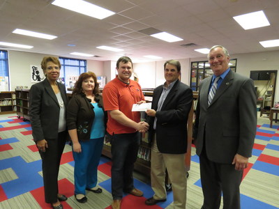 Georgia Power announced the selection of 41 new teachers from across the state to receive one of the company's annual $1,000 New Teacher Assistance Grants. Pictured is Caleb McKeever, of Milledgeville receiving his New Teacher Assistance Grant check.