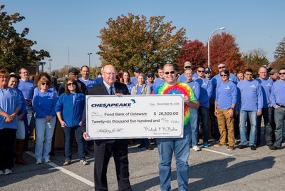Chad Robinson, Milford Branch Director of the Food Bank of Delaware (right) accepts a donation made on behalf of Chesapeake Utilities Corporation, presented by Michael P. McMasters, Chesapeake Utilities Corporation President and Chief Operating Officer (left).