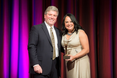 Elaine Bittner, Senior Vice President of Strategic Development, Chesapeake Utilities Corporation (right) receives a Gold Stevie Award for Female Executive of the Year at the 2016 Stevie Awards for Women in Business - presented by Michael Gallagher, President of the Stevie Awards (left).
