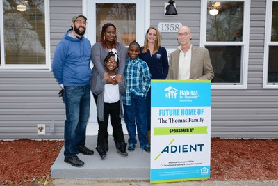 Adient, the world's largest global automotive seating supplier, presented the keys to an Ypsilanti Township home to Christina Thomas and her family (center) this week . Russ Burgei, (far right) vice president of engineering for Adient and the company's Habitat for Humanity project leader, and representatives from Habitat of Huron Valley took part in the event.