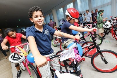 Children from the Boys and Girls Club of South Beach test their new bikes.