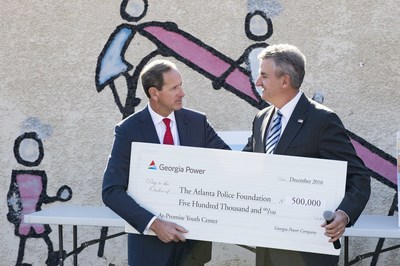 Paul Bowers, chairman, president and CEO of Georgia Power presents a check to Dave Wilkinson, President and CEO, Atlanta Police Foundation.