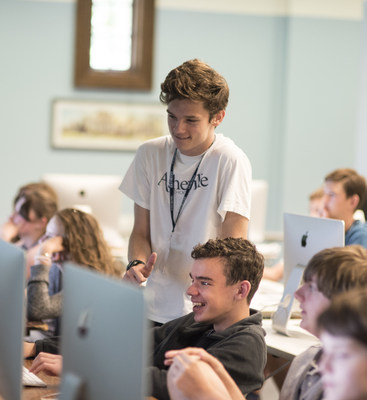 Gabriel Wong, a 14-year-old Asheville School student from the Bahamas, shares a moment with Georgia Tech student Jack Hamilton (standing) during Asheville School's App Development Summer Camp. Wong created his own app, "Go Switchy," weeks after attending the app camp. Asheville School is one of the first schools in the country to integrate Apple's Swift programming language into its academic and extracurricular program.