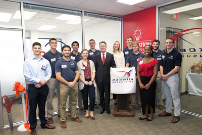 Virginia Tech President Tim Sands celebrates with students from Excella Consulting's Extension Center program at the grand opening of their new office in the Virginia Tech Corporate Research Center.