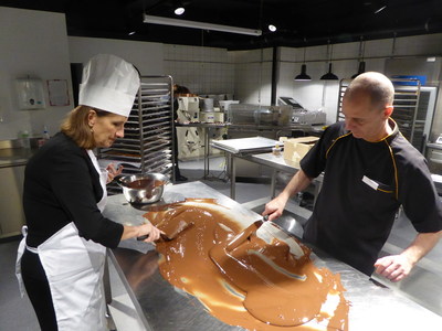 Tour de Chocolat participant works with chocolatier Blaise Poyet at Laderach studios in Vevey Switzerland