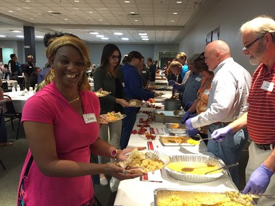 A warrior is all smiles as the food is served by volunteers at a Thanksgiving dinner event hosted by Wounded Warrior Project and Christ's Church in Jacksonville, FL.